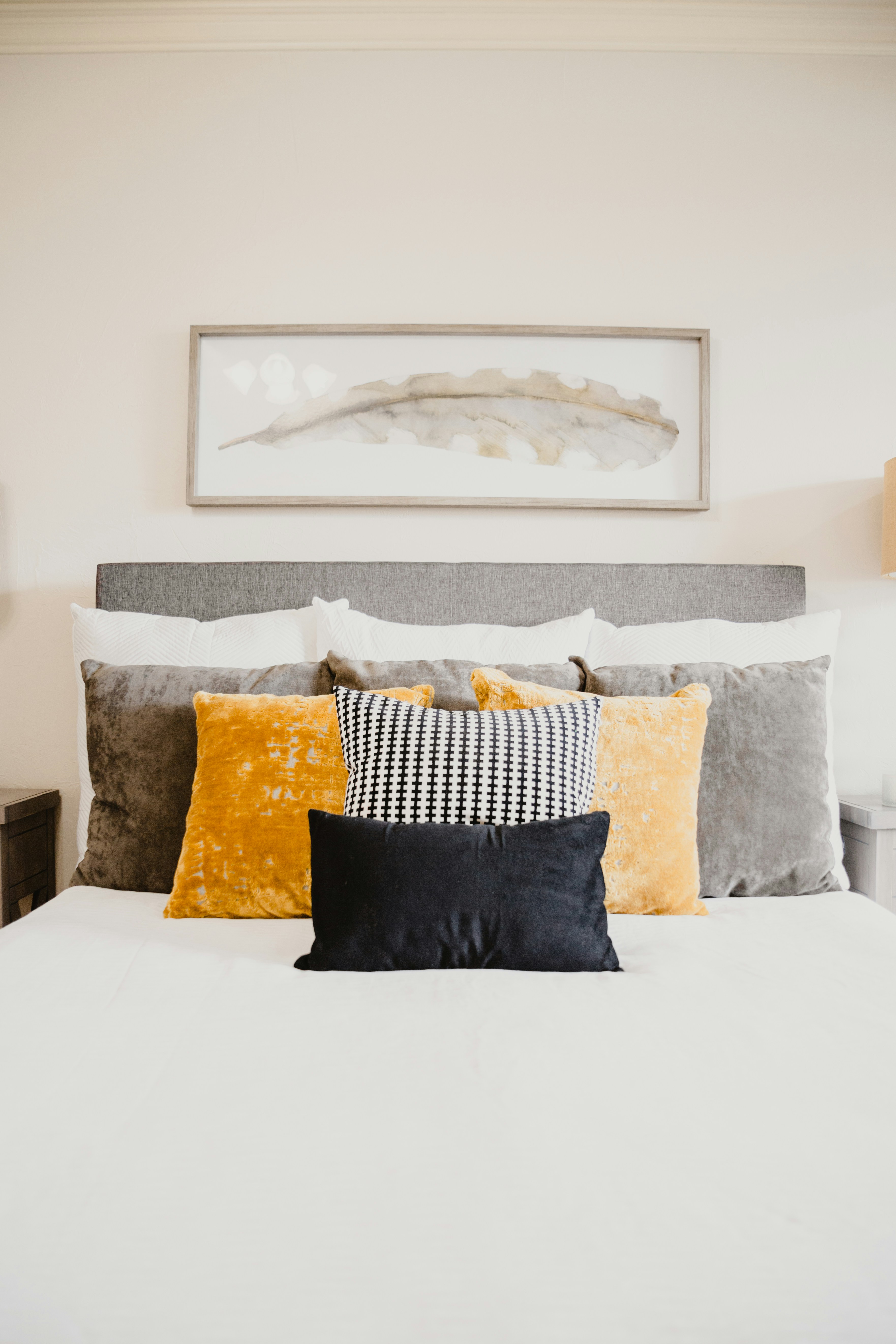 Luxuriously styled bed with layered cushions — hotel-quality bedding